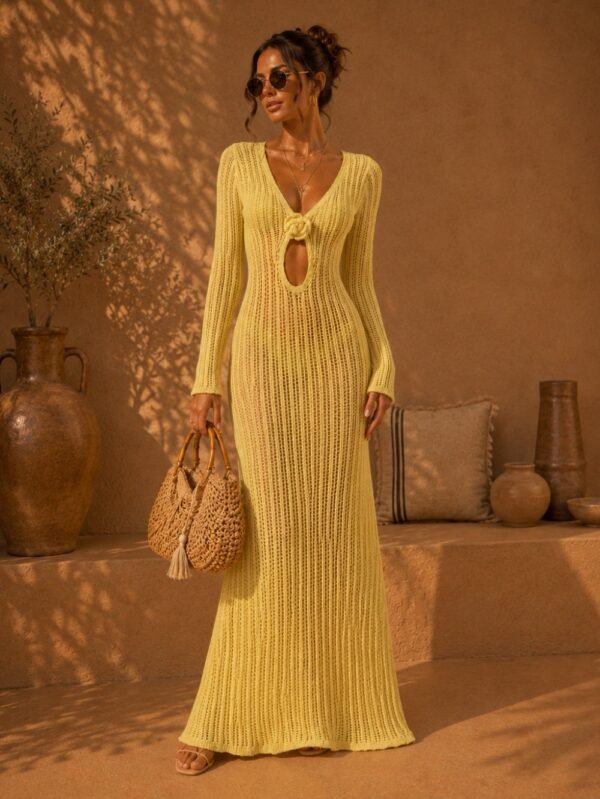 Woman wearing yellow crochet open-back maxi dress with resortwear styling and woven beach bag